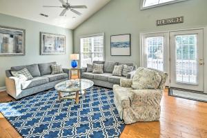 a living room with a couch and a table and chairs at 1 Mi to Beach and Hot Tub Murrells Inlet Retreat! in Myrtle Beach