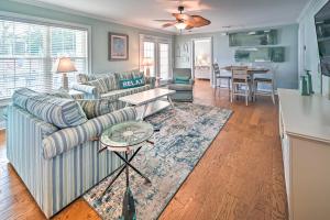 a living room with a couch and a table at 1 Mi to Beach and Hot Tub Murrells Inlet Retreat! in Myrtle Beach