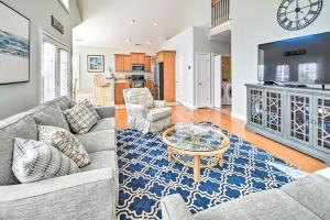 a living room with a couch and a table at 1 Mi to Beach and Hot Tub Murrells Inlet Retreat! in Myrtle Beach