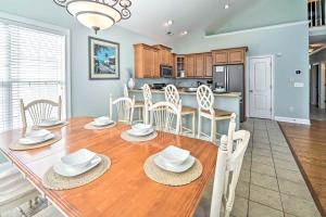 a dining room and kitchen with a table and chairs at 1 Mi to Beach and Hot Tub Murrells Inlet Retreat! in Myrtle Beach
