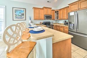 a kitchen with wooden cabinets and stainless steel appliances at 1 Mi to Beach and Hot Tub Murrells Inlet Retreat! in Myrtle Beach