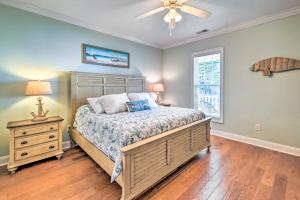 a bedroom with a bed and a dresser and a window at 1 Mi to Beach and Hot Tub Murrells Inlet Retreat! in Myrtle Beach