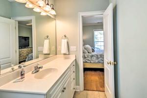 a bathroom with a sink and a mirror at 1 Mi to Beach and Hot Tub Murrells Inlet Retreat! in Myrtle Beach