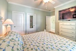 a bedroom with a bed and a flat screen tv at 1 Mi to Beach and Hot Tub Murrells Inlet Retreat! in Myrtle Beach