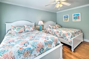 a bedroom with two beds and a ceiling fan at 1 Mi to Beach and Hot Tub Murrells Inlet Retreat! in Myrtle Beach +37 photos