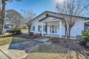 a white building with a sign that reads masters center at 1 Mi to Beach and Hot Tub Murrells Inlet Retreat! in Myrtle Beach