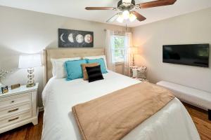 um quarto com uma cama e uma ventoinha de tecto em Recently Renovated Raleigh Retreat with Patio! em Raleigh