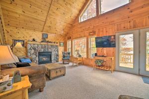 a living room with a couch and a fireplace at Lakefront Hawks Getaway - Fire Pit and Kayaks! in Hawks