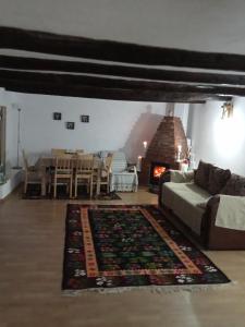 a living room with a couch and a fireplace at Casuta din Deal in Vaideeni