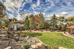 a backyard with a lawn and a rock garden at Reno Home with Private Yard and Hot Tub in Reno