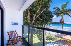 a balcony with a view of the beach at Hotel Village Enseada in Ubatuba