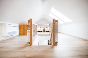 an empty room with a crib in a attic at Hiša 109 in Kranjska Gora +32 photos