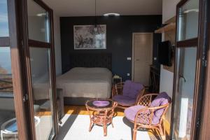 a room with a bed and a table and chairs at Apartman Andjela in Kopaonik
