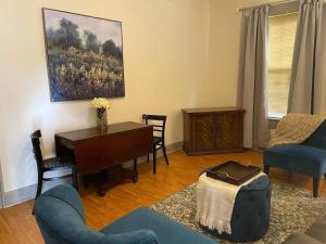 a living room with a blue couch and a table at Oui! Not Your Grandmother's Property in Knoxville