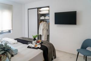A television and/or entertainment centre at The Lop Athens Holidays Luxury Suites