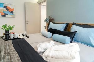 A bed or beds in a room at The Lop Athens Holidays Luxury Suites