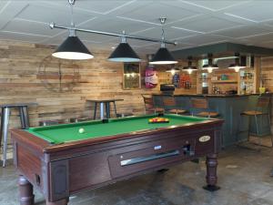 a pool table in a room with a bar at Peacock Lake Glamping in Nottingham