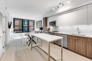 a kitchen with white cabinets and a table and chairs at Global Luxury Suites at Capitol Hill in Washington, D.C.