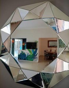 a mirror reflection of a living room with a table at La Casa de la Puerta Azul in Mendoza