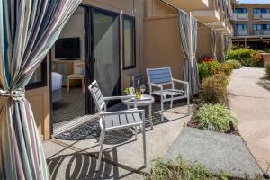 a patio with two chairs and a table on a balcony at The Lodge at Tiburon in Tiburon