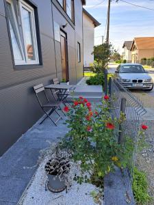 a house with a patio with a table and flowers at Apartments Stars in Velika Gorica