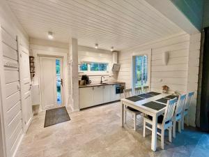 a kitchen with a table and chairs in a room at Jõiste Beach Villa in Jõiste