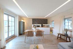 eine Küche und ein Wohnzimmer mit einem Tisch und Stühlen in der Unterkunft Traumhaftes Gästehaus an Elberadweg und Bastei in Rathen