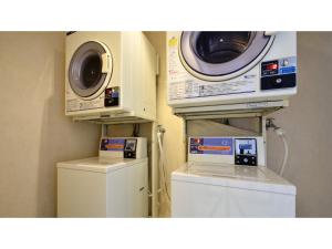 a laundry room with a washing machine and a dryer at Hotel Tamano - Vacation STAY 41648v in Otawara