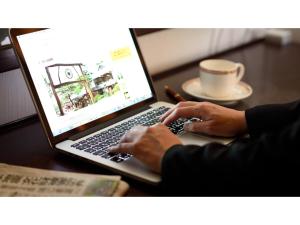 a person typing on a laptop computer on a desk at Hotel Tamano - Vacation STAY 41642v in Otawara