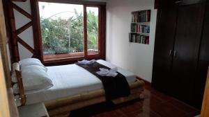 sypialnia z łóżkiem i oknem w obiekcie Apto/cabaña naranja w mieście Ulloa