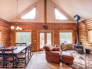 a dining room with a table and a fireplace at Secluded Log Cabin with Views & Hot Tub, Foosball, Wood Stove - Heavenly Homestead in Fairplay