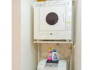 a microwave oven sitting on top of a washing machine at Hotel Sunset Zanpa - Vacation STAY 50194v in Tokeshi