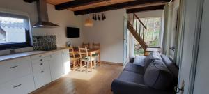 a living room with a couch and a kitchen and a table at Lavendowo in Piechowice