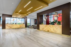 a lobby of a hotel with marble floors and a gold ceiling at Costa Hollywood Beach Resort - An All Suite Hotel in Hollywood