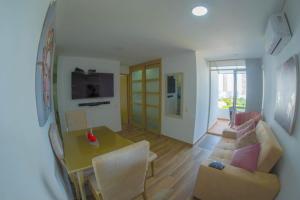 a living room with a table and a couch at Exclusive House Cartagena in Cartagena de Indias +10 photos