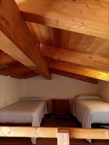 2 camas en una habitación con techos de madera en Casale Nel Verde, en San Vito Chietino