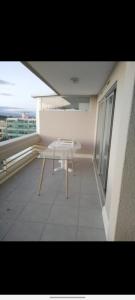 a white table on the balcony of a building at Appartement Ipanema Sud in Canet-en-Roussillon