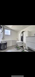 a bathroom with a tub and a toilet and a sink at La villa petite Camargue in Saint-Louis