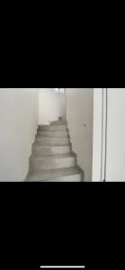 a stairway in a building with a stair case at La villa petite Camargue in Saint-Louis