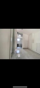 an empty room with white walls and a hallway at La villa petite Camargue in Saint-Louis