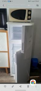 a white refrigerator with a microwave on top of it at Appartement Ipanema Sud in Canet-en-Roussillon