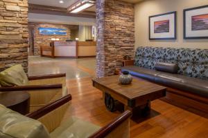 a lobby with a leather couch and a coffee table at The Lodge at Tiburon in Tiburon