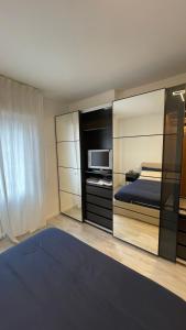 una camera da letto con un letto, una TV e un letto di una piazza di Casa Veronica nel cuore di Padova a Padova
