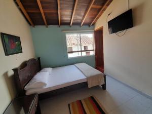 TV a/nebo společenská místnost v ubytování HOSTAL HELICONIAS