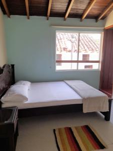 Postel nebo postele na pokoji v ubytování HOSTAL HELICONIAS