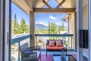 a screened porch with a view of the mountains at Snowbird by Elevate Vacations in Whistler