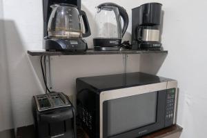 a microwave and a blender on a shelf at Casa Aurora #3: Private room in excellent location in Puerto Vallarta
