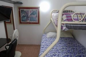 a small room with a bunk bed and a desk at Casa Aurora #3: Private room in excellent location in Puerto Vallarta