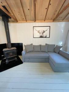 a living room with a couch and a stove at Leland’s Lakehouse in Wolfville