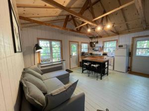 a living room with a couch and a table in a kitchen at Leland’s Lakehouse in Wolfville
